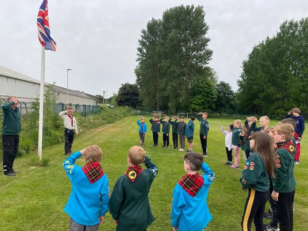 Young members with their flag at a Scouts event